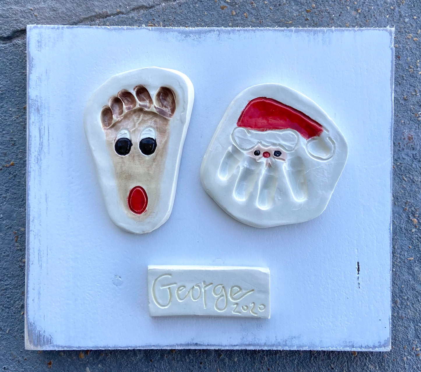 Santa Hand and Reindeer Foot on White Wood